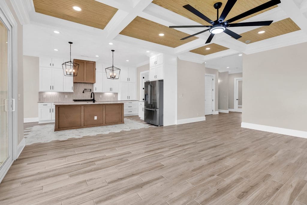 Modern kitchen and living area in a Myrtle Beach home—showcasing what’s possible when choosing to build instead of buy in South Carolina.