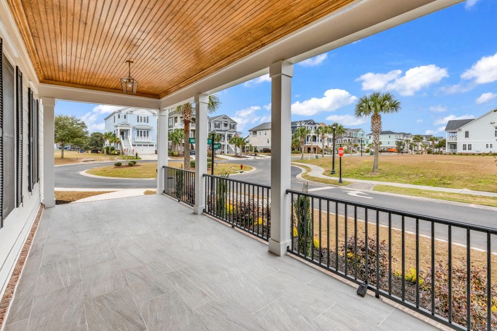 Custom home front porch featuring durable, low maintenance materials in a coastal design.
