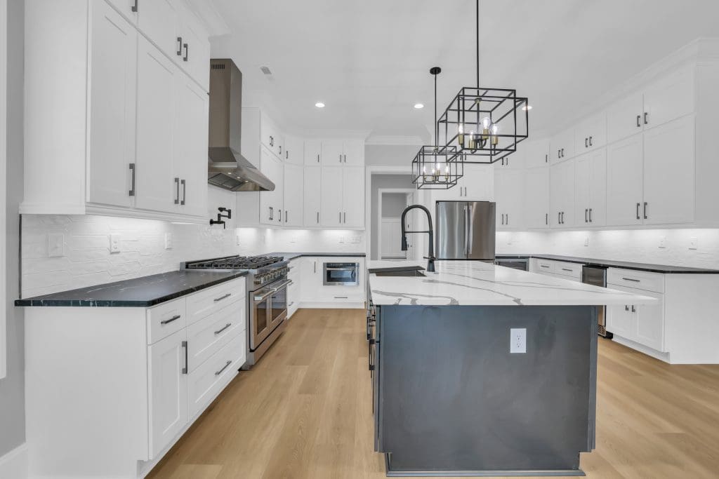 High contrast custom kitchen design showing how timing home sale with new build creates a seamless move-in.