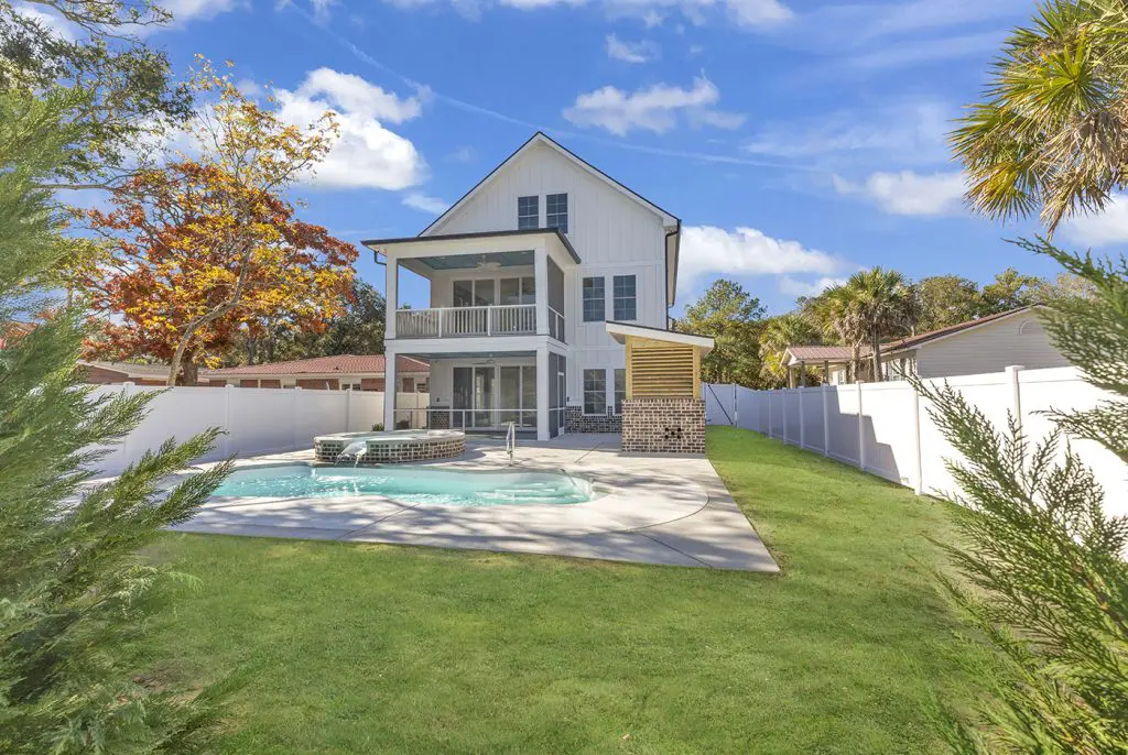 Rear exterior of home with lush greenery and landscaping, illustrating outdoor living space ideas.