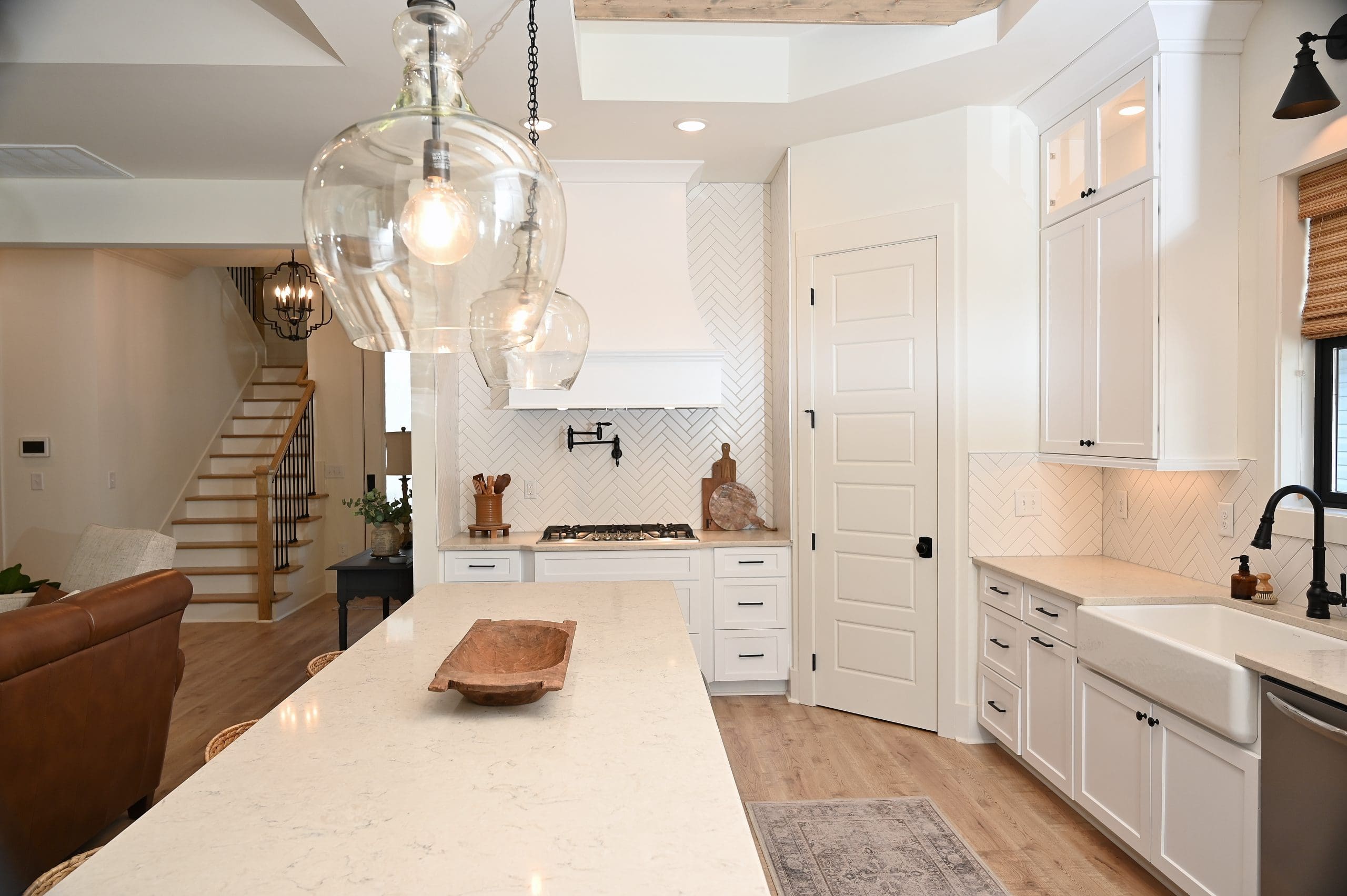 Bright coastal kitchen featuring universal design elements like accessible countertops, wide pathways, and stylish, functional layout for all abilities.