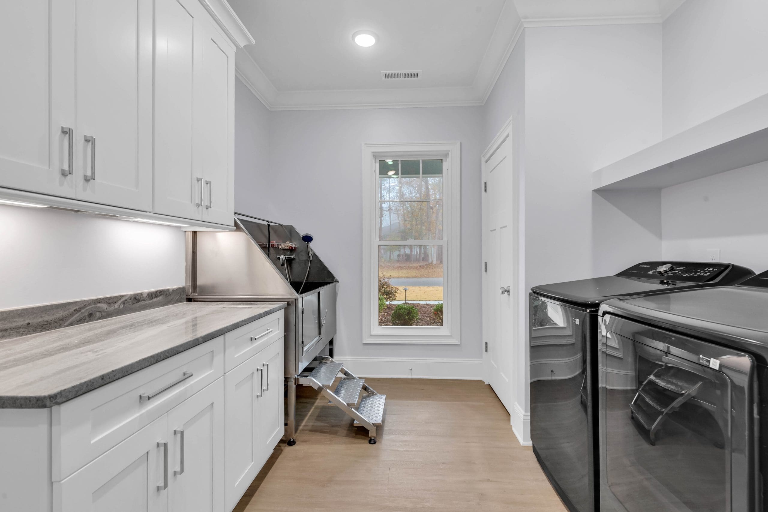 Energy-efficient laundry room featuring a washer and dryer, designed to optimize energy use and provide functional convenience.