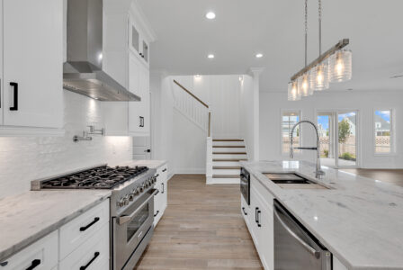 Modern accessible home kitchen with open floor plan, lowered countertops, and wide walkways for easy mobility.