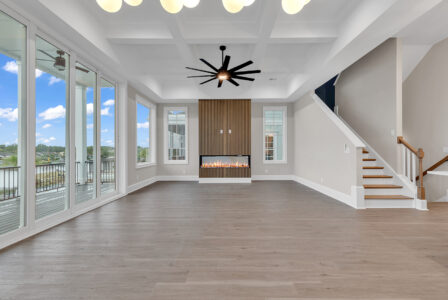 Open-concept living space with large windows and coastal views, illustrating design choices that help protect your budget when building custom.