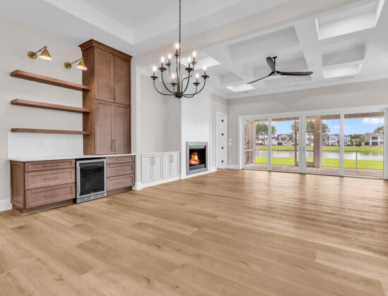 Living room with open layout leading to outdoor patio, illustrating how to choose a floor plan with functional indoor-outdoor flow.