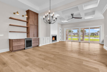 Living room with open layout leading to outdoor patio, illustrating how to choose a floor plan with functional indoor-outdoor flow.