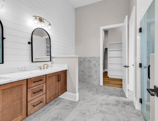 Modern coastal bathroom with wide, open space designed for universal accessibility.