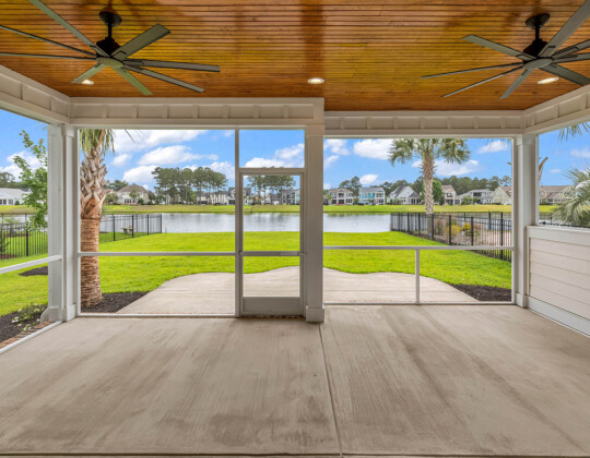 Covered porch with lighting showcasing outdoor living space ideas for year-round enjoyment.