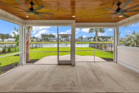 Covered porch with lighting showcasing outdoor living space ideas for year-round enjoyment.