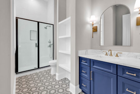 Stylish modern bathroom in a guest suite, designed for comfort and convenience in first-floor living.