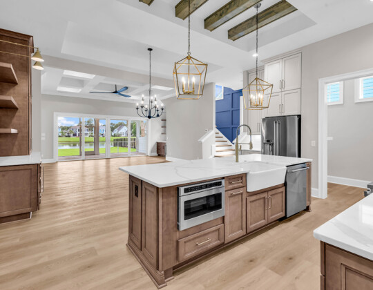 Bright living room and kitchen with open layout showcasing the benefits of first-floor living for seamless daily flow and accessibility.