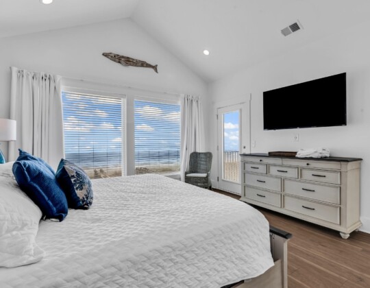 Bright coastal bedroom showcasing thoughtful layout decisions that reflect the smartest decisions to make before building a custom home.