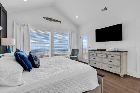 Bright coastal bedroom showcasing thoughtful layout decisions that reflect the smartest decisions to make before building a custom home.
