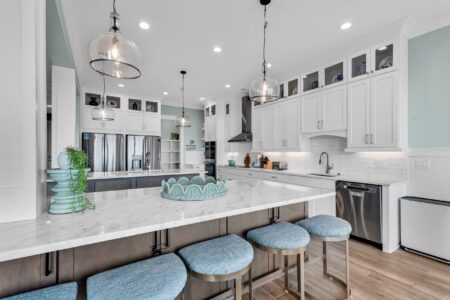 Bright coastal kitchen highlighting layout and storage choices that reflect the smartest decisions to make before building a custom home.