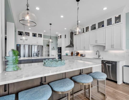 Bright coastal kitchen highlighting layout and storage choices that reflect the smartest decisions to make before building a custom home.