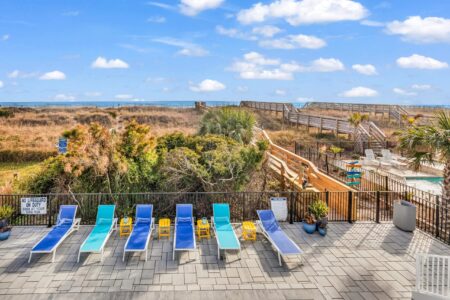 lounge chairs by pool of S Ocean home by swift creek homes