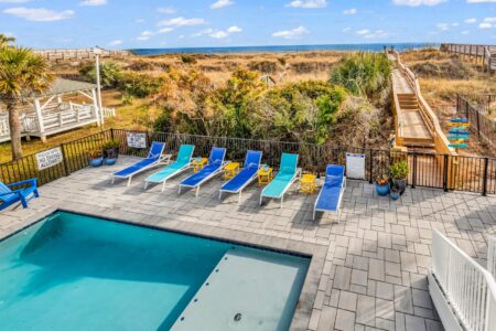 lounge chairs by pool of S Ocean home by swift creek homes