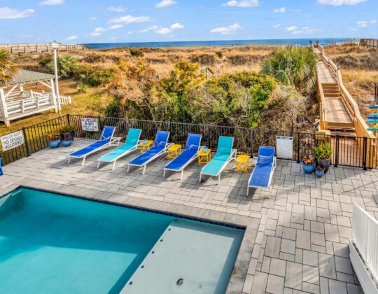 lounge chairs by pool of S Ocean home by swift creek homes