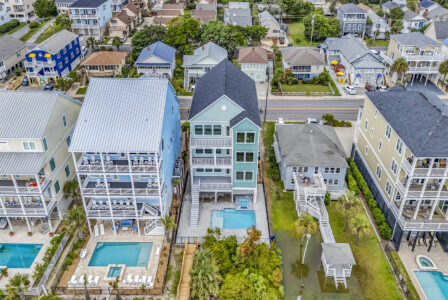 Oceanfront coastal custom homes along the Myrtle Beach shoreline, featuring elevated designs, private beach access, and durable construction—illustrating key factors that influence the cost of building on the Grand Strand.