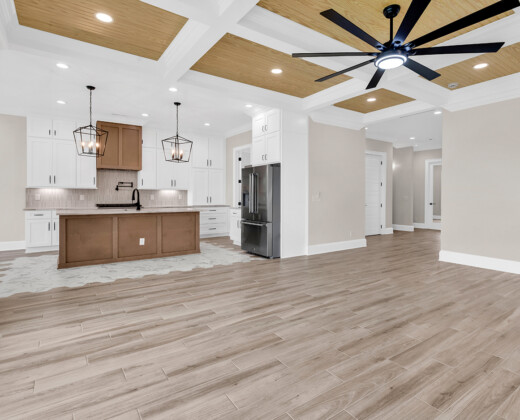 Modern kitchen and living area in a Myrtle Beach home—showcasing what’s possible when choosing to build instead of buy in South Carolina.