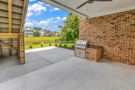 rear porch and outdoor kitchen of Whispering Winds home