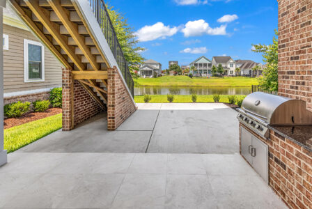 rear porch and outdoor kitchen of Whispering Winds home