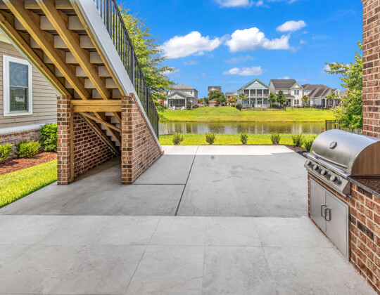 rear porch and outdoor kitchen of Whispering Winds home