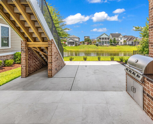 rear porch and outdoor kitchen of Whispering Winds home